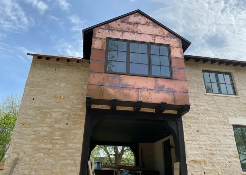 Copper metal panel facade on a stone building for Skylight Installation in Hobbs